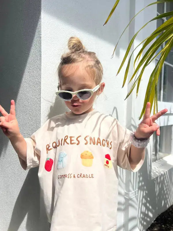 child wearing a t-shirt with graphics of snacks