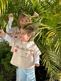 Two sibling children in matching graphic beige t-shirts australia