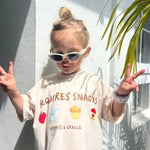child wearing a t-shirt with graphics of snacks
