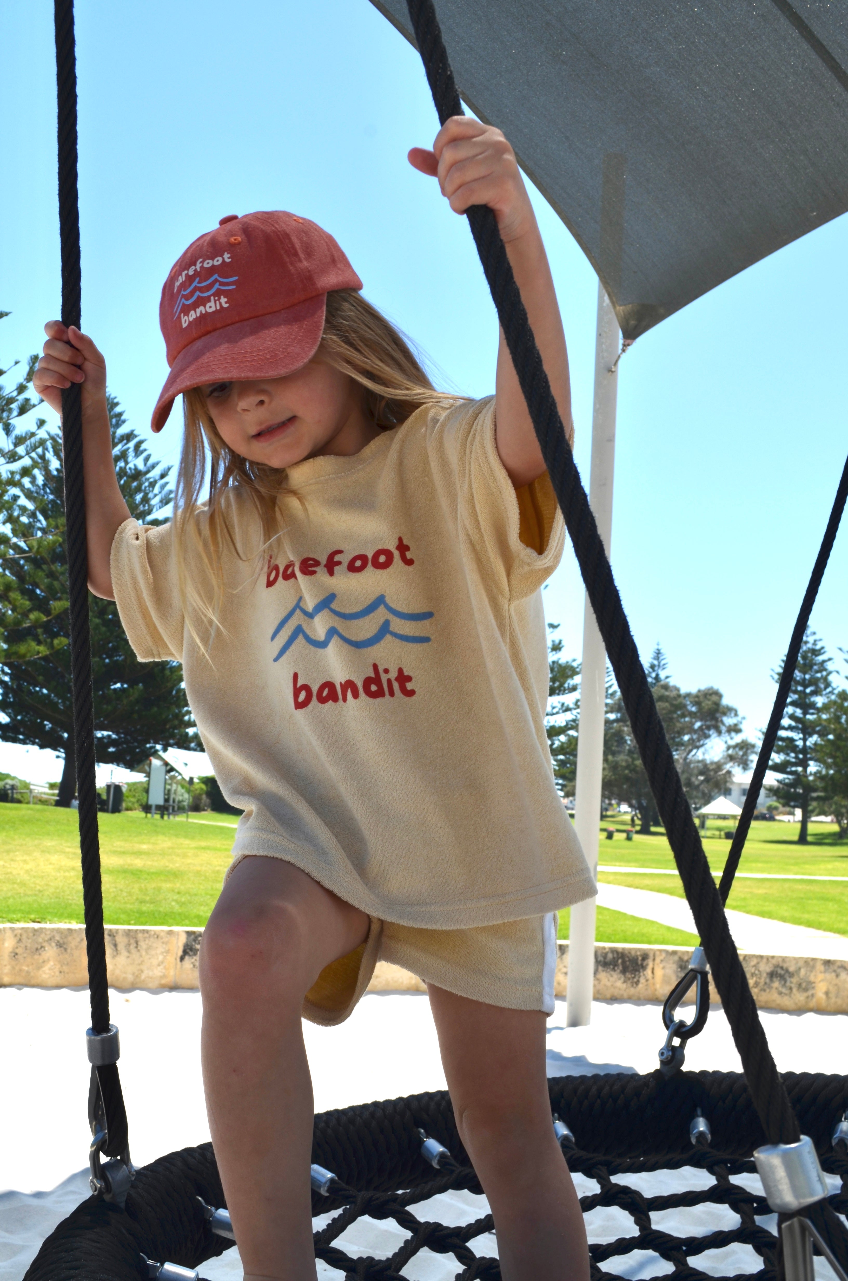 Child wearing Barefoot Bandit kids terry towelling shirt in soft cotton, Australian coastal kidswear by Compass & Cradle.
