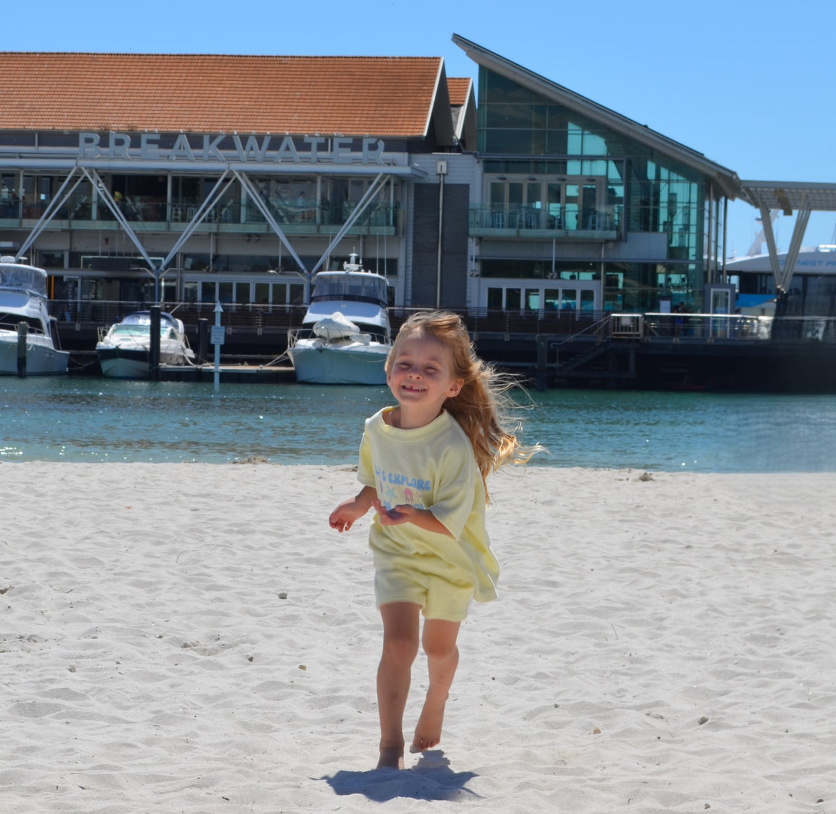 Kids summer beach outfit with matching mums cap, playful slogan design, and soft terry towelling