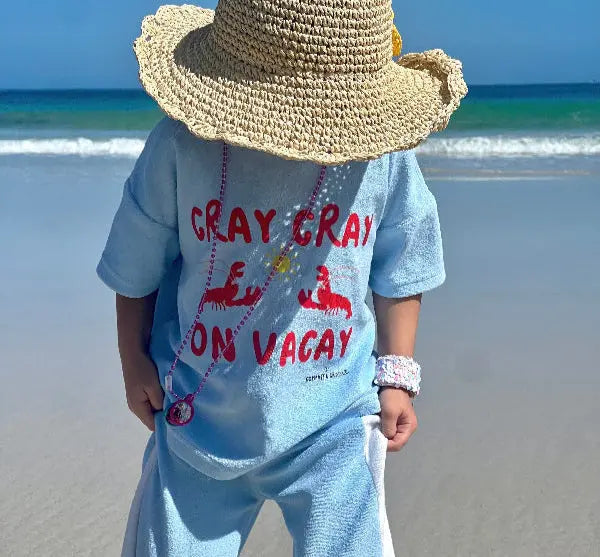Kid wearing a terry cloth pants clothing set while on the beach