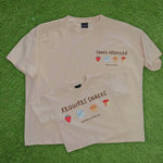 Two beige-colored t-shirts with snack-themed graphics and text on a beige background